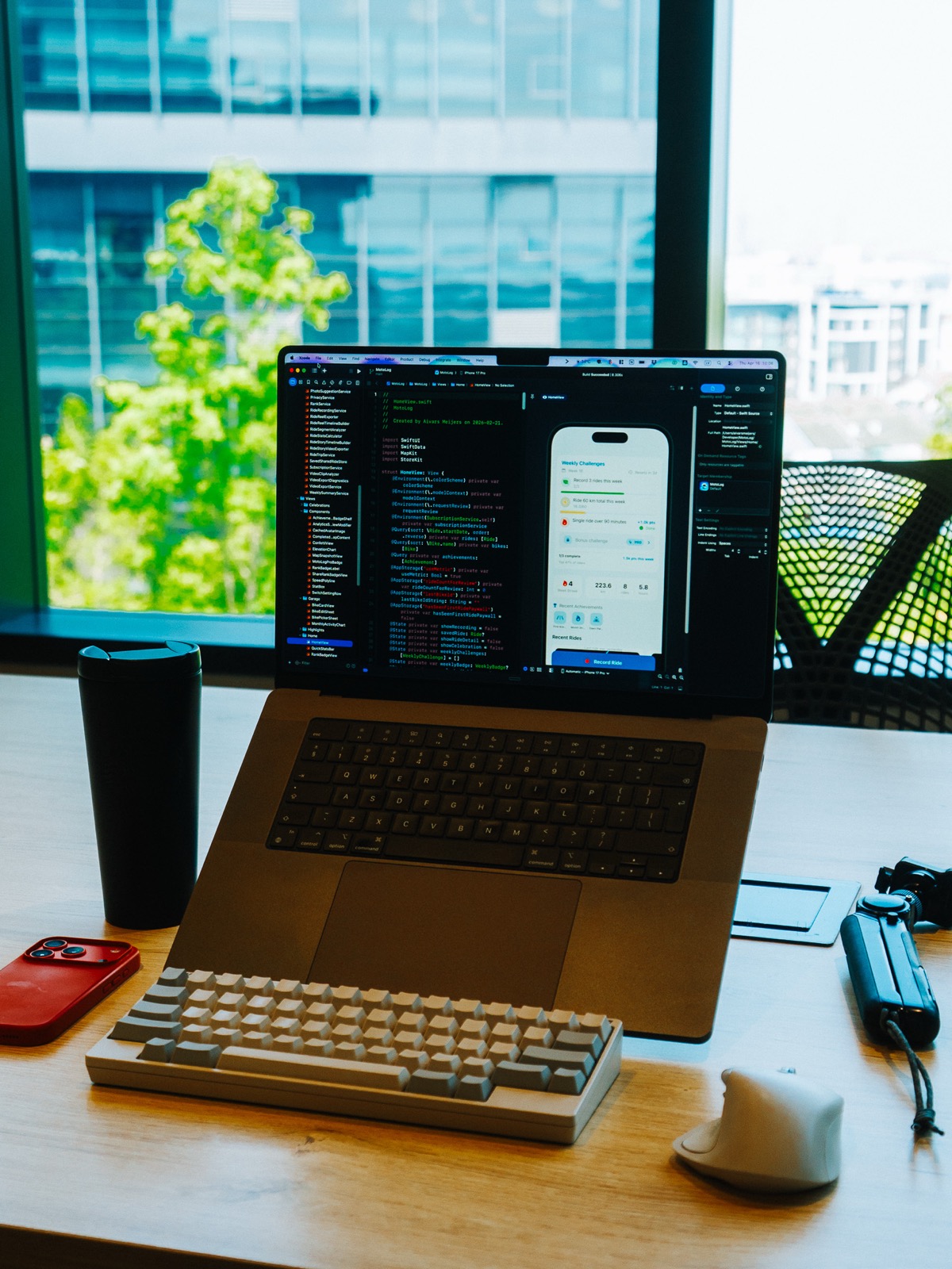 Aivars Meijers building an iOS app in Xcode by a city window